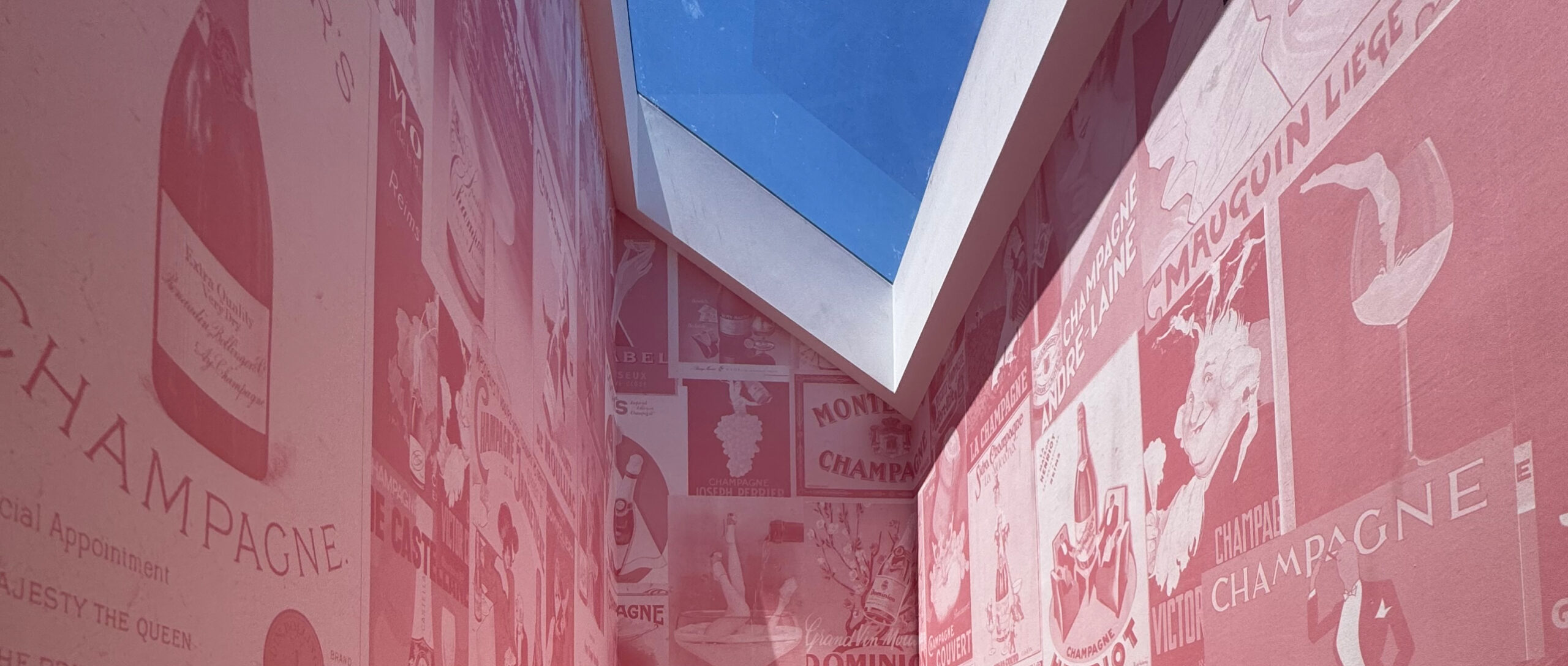 Pink hallway wallpapered with a sky light